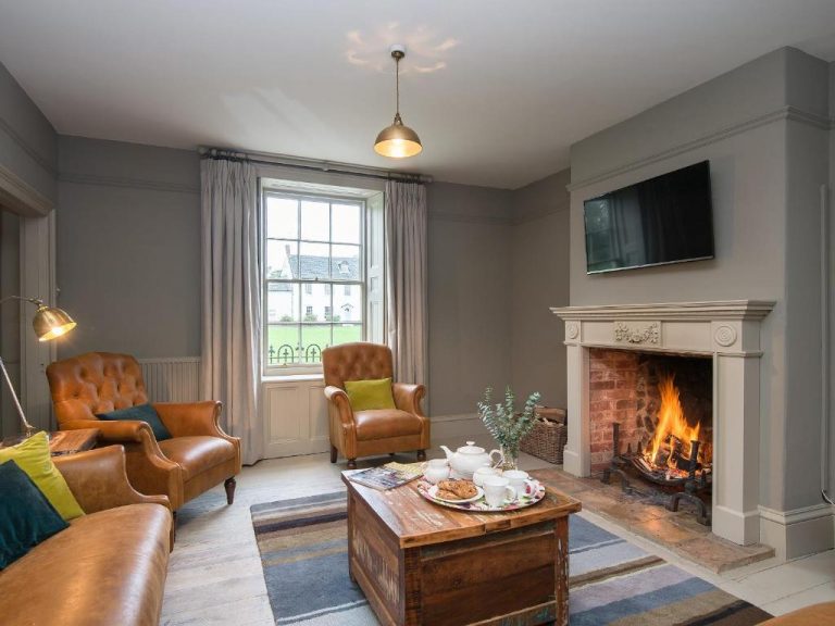 Open Fireplace leather armchairs in a Norfolk Holiday Let near Fakenham