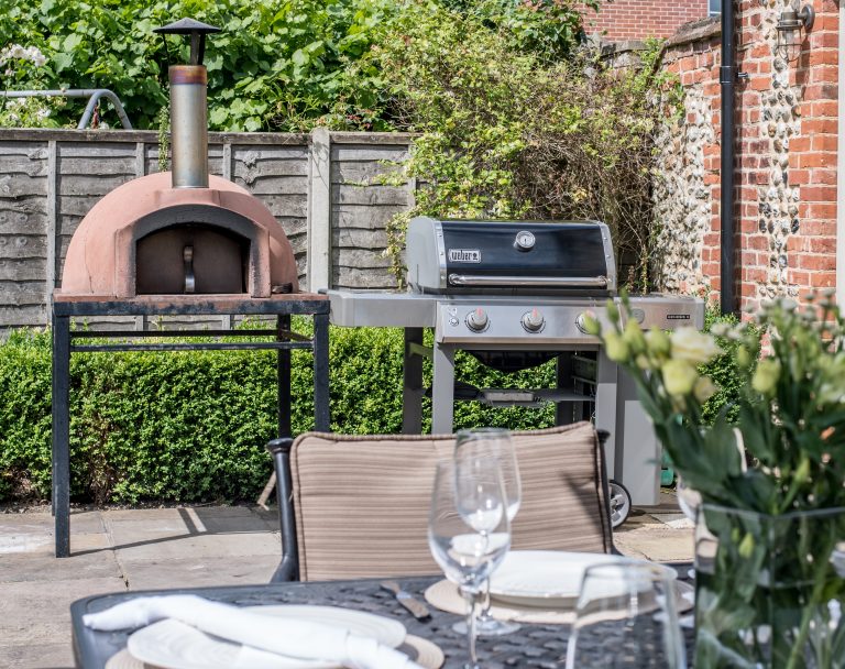 Webber Gas BBQ and Ceramic Pizza Oven in a Norfolk Holiday Rental Patio Area