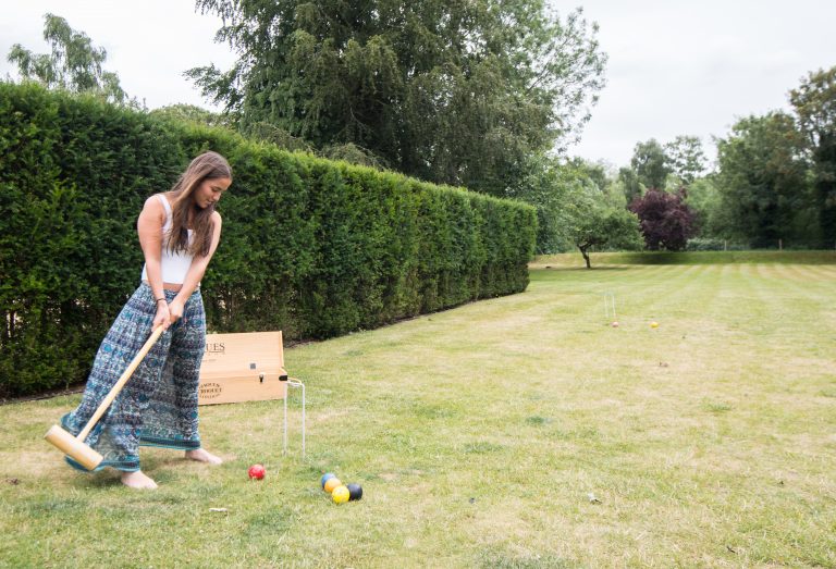 Girl playing Croquet in the large garden of a Norfolk Holiday Home